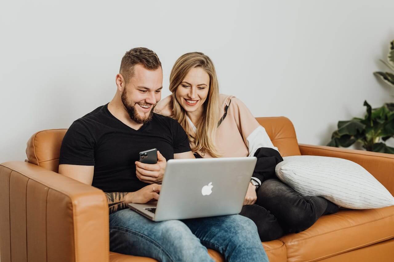 Happy couple completing paid surveys